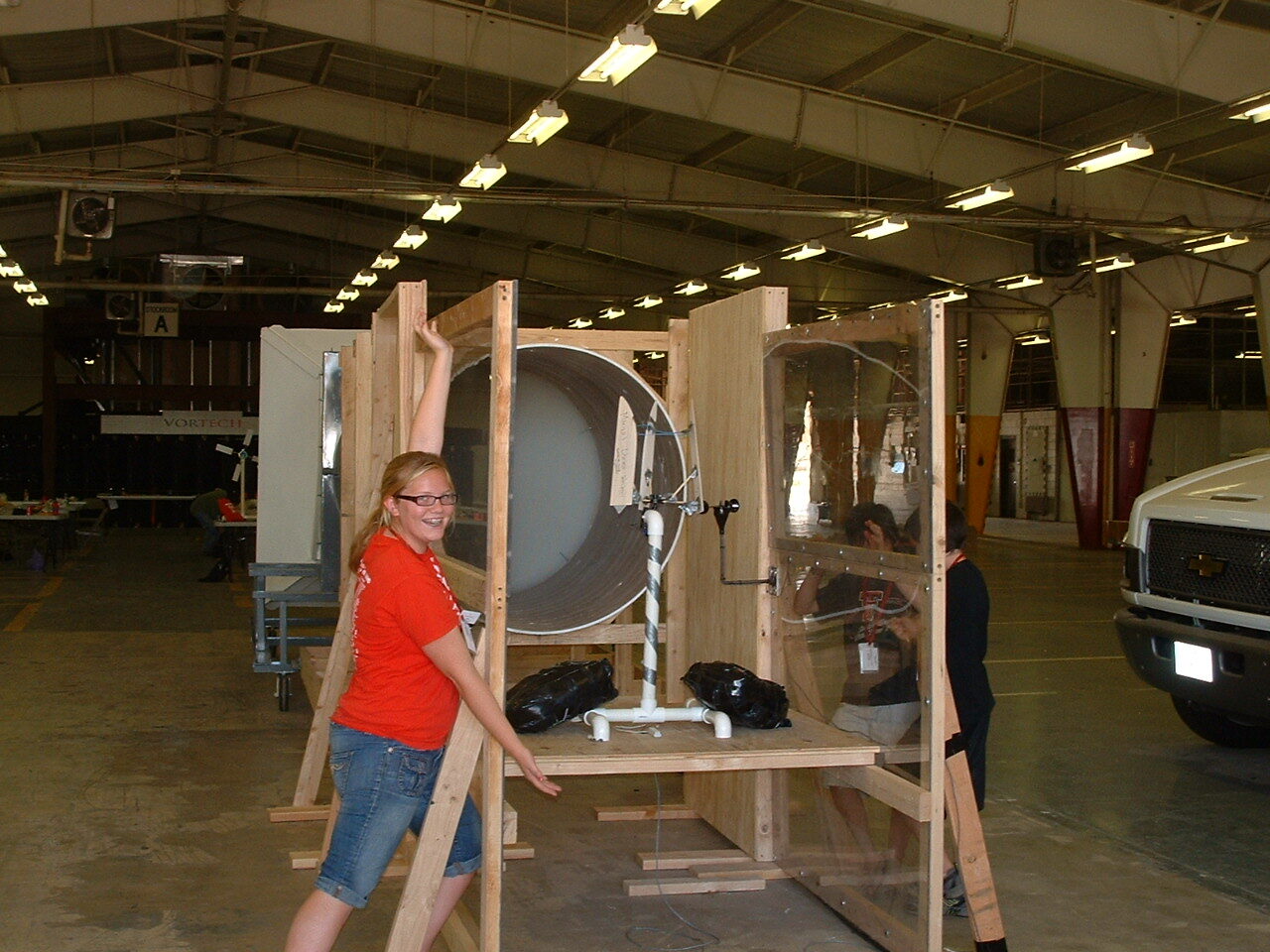 Student beside a homemade wind tunnel at the Run on the Wind summer camp