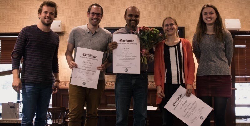 Sukanta Basu with colleagues holding teaching-award certificates